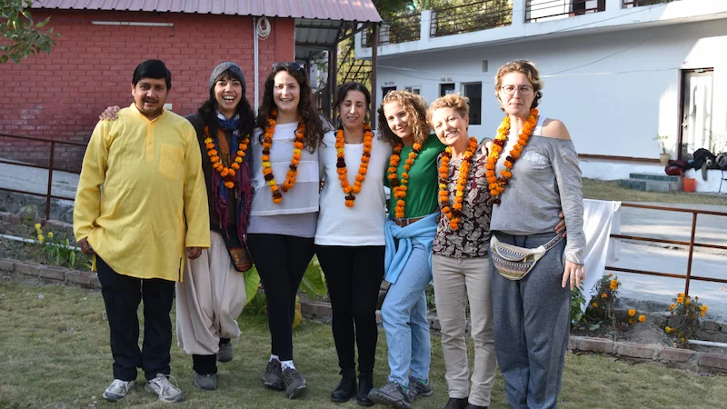 A small group practicing yoga in a foundational 100-hour course in Rishikesh