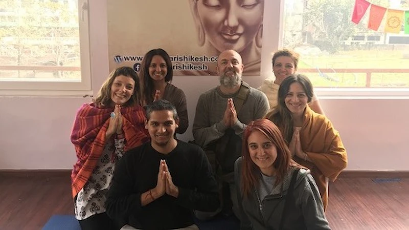 Students in a circle practicing yoga during a 200 Hour Teacher Training course at Raj Yoga Rishikesh