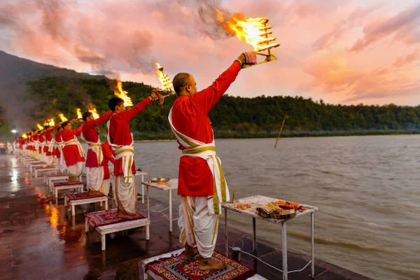 A vibrant Ganga Aarti ceremony at sunset in Rishikesh.