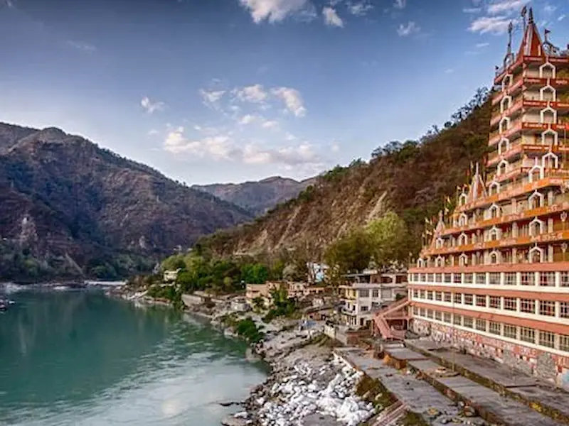 Serene view of the Ganga river and temples in Rishikesh, India.