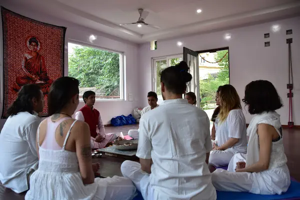 Students practicing yoga in a 200 Hour Teacher Training Course