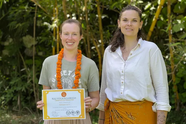 Students celebrating Yoga Alliance certification ceremony at Raj Yoga Rishikesh, India