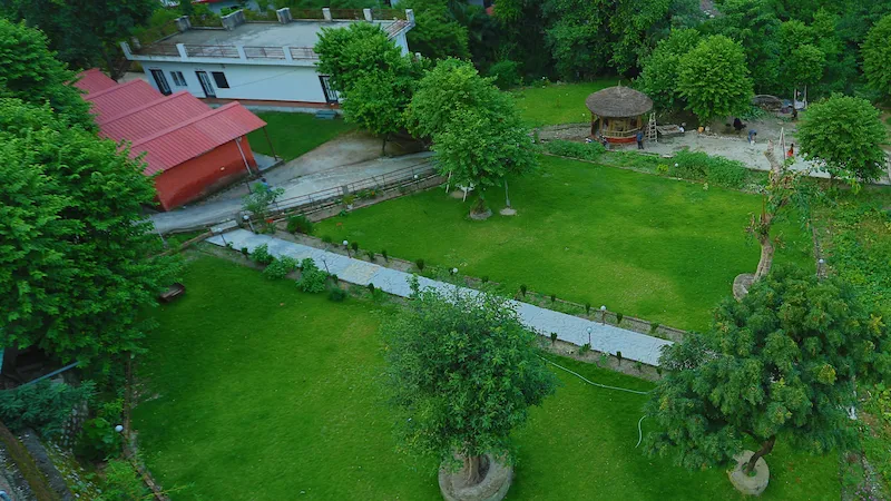 A yoga teacher guiding a group in a beautiful yoga hall in Rishikesh